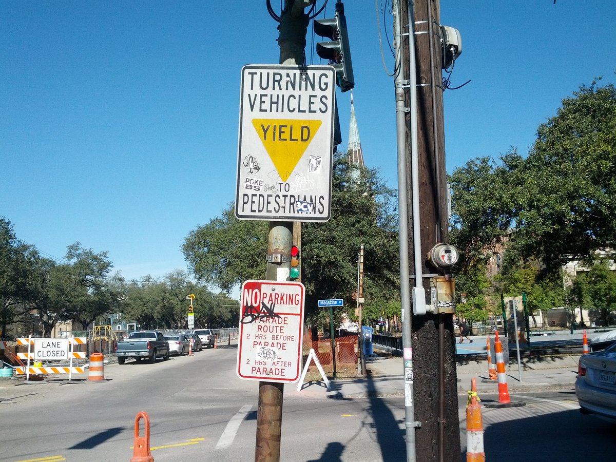 Street intersection with signs, traffic lights, vehicles, cones and barriers, every object boxed.